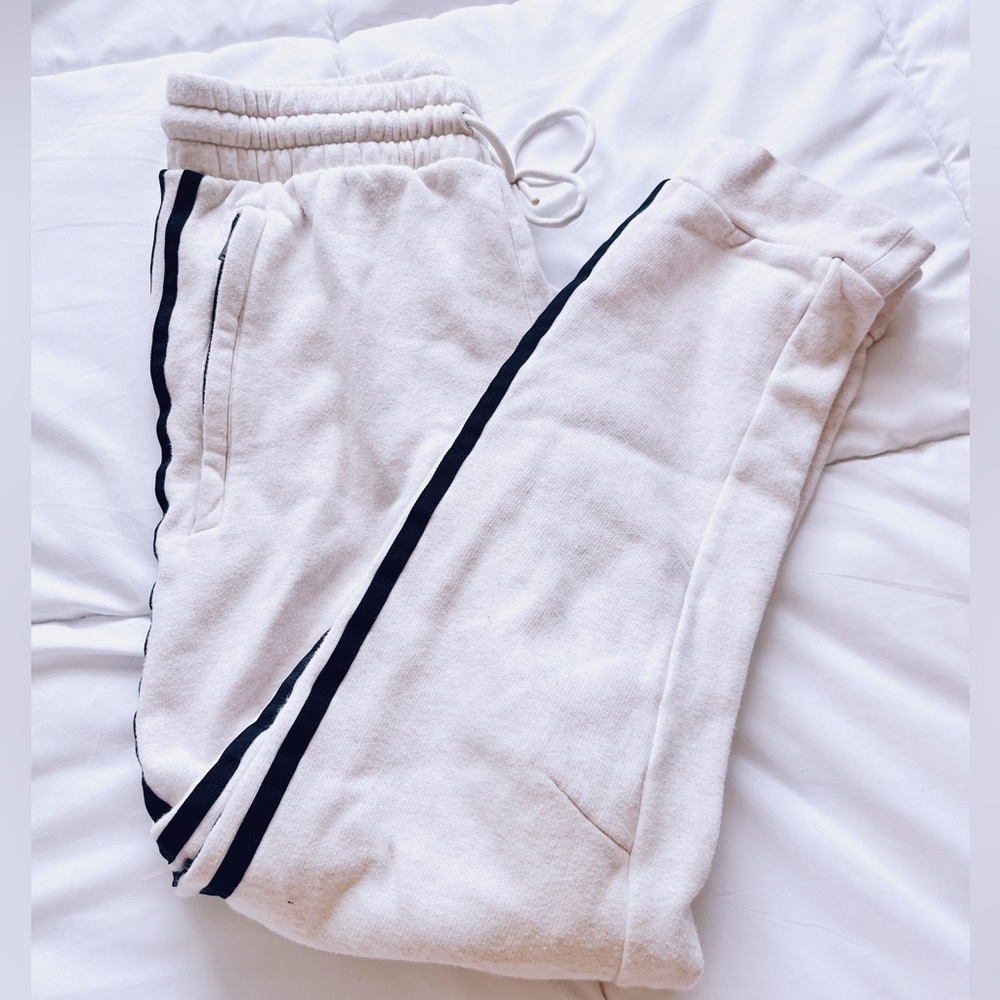 cream colored adidas sweatpants, joggers